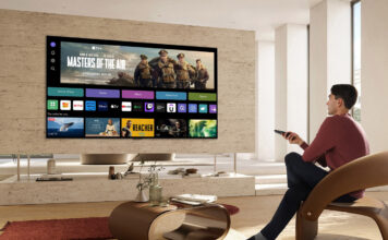 Man watching TV with smart TV interface onscreen.